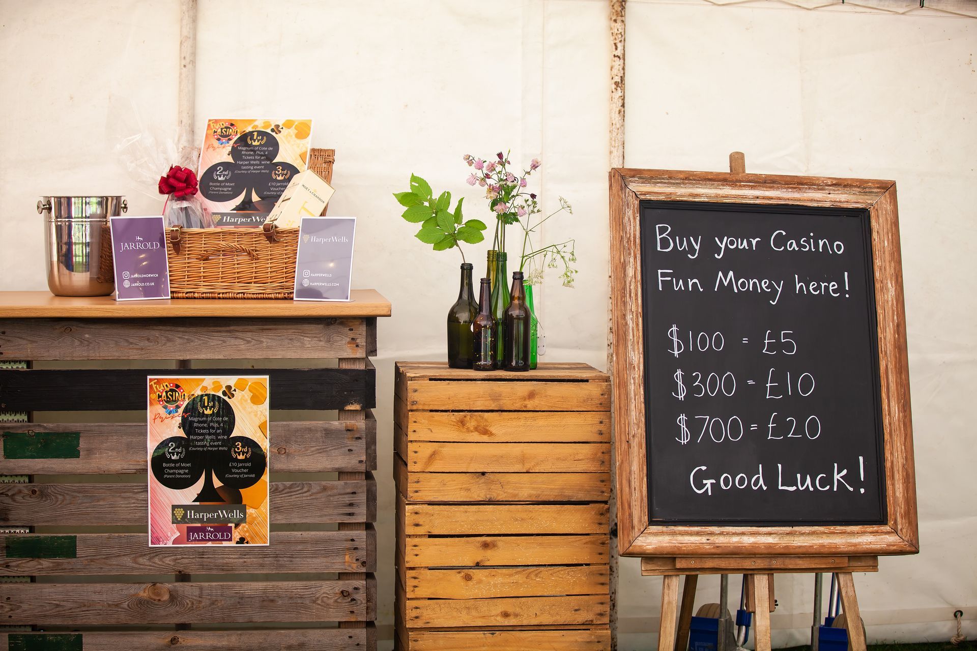 Casino fun money station with chalkboard sign, bottle vase, and money signs.