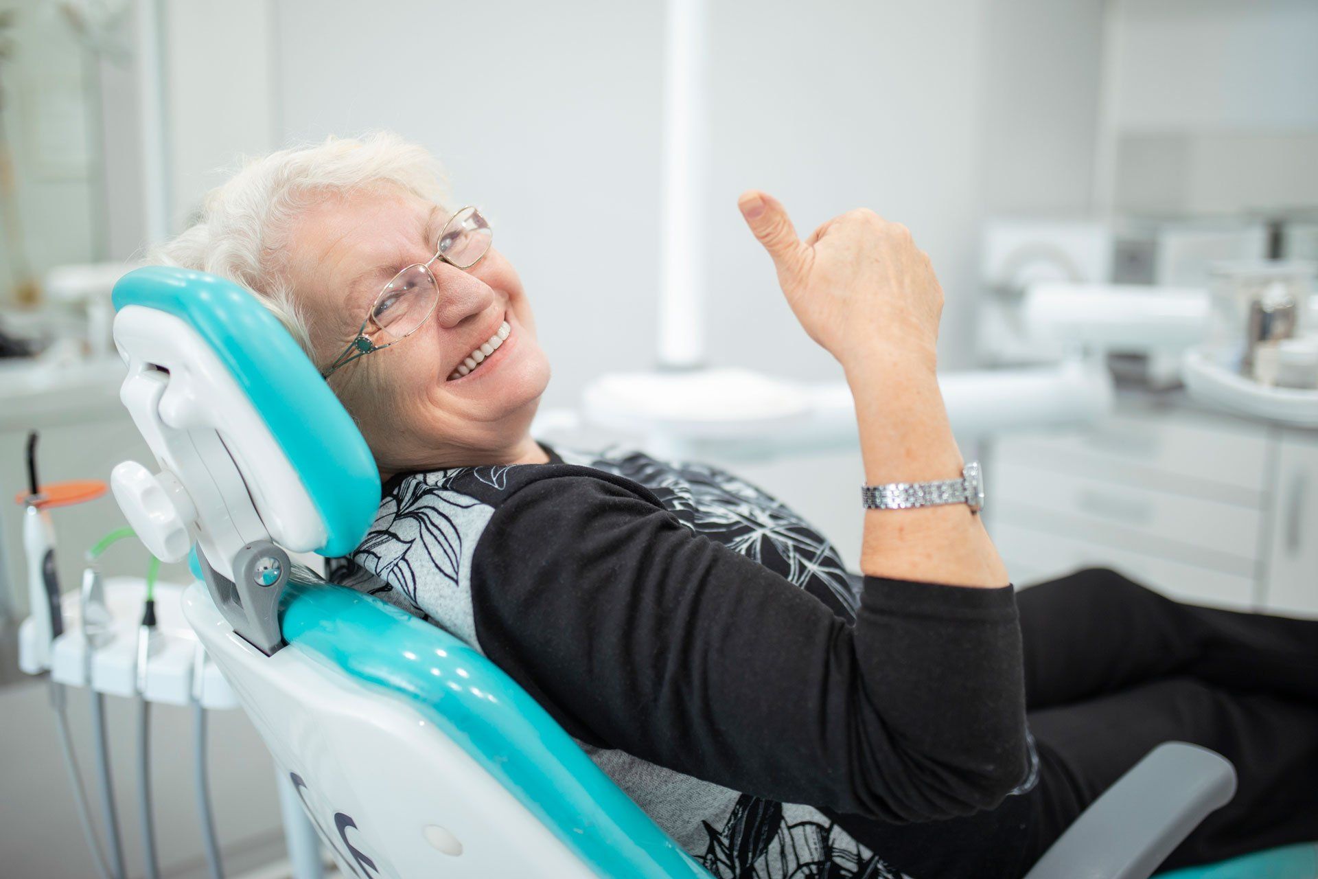 Woman Sitting in a Dental Chair — Visalia, CA — Dr. Gregory B. Halls