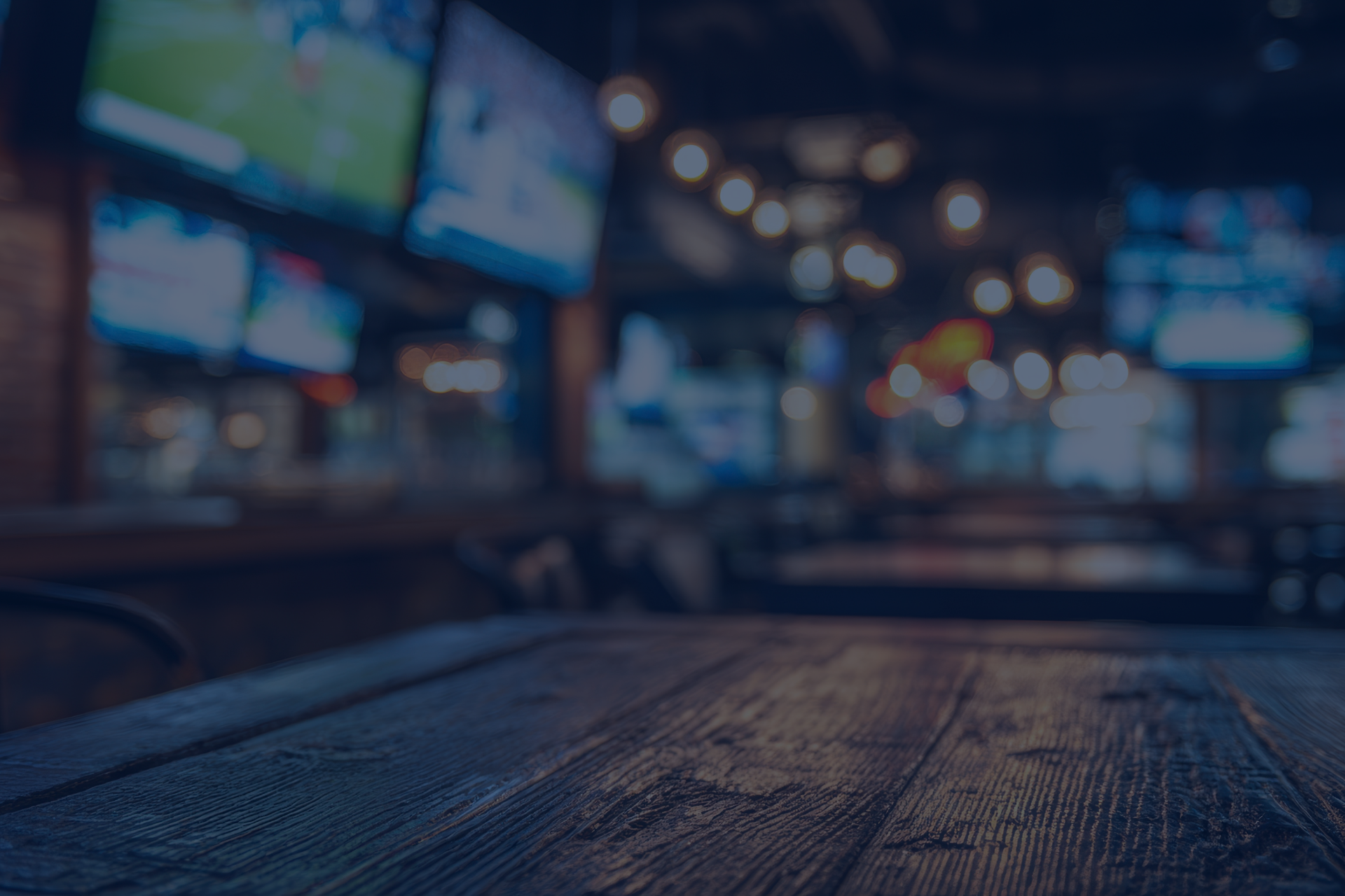 Image of a pub displaying sports on TV and table, with a quote around the ease of the Purple Hub.