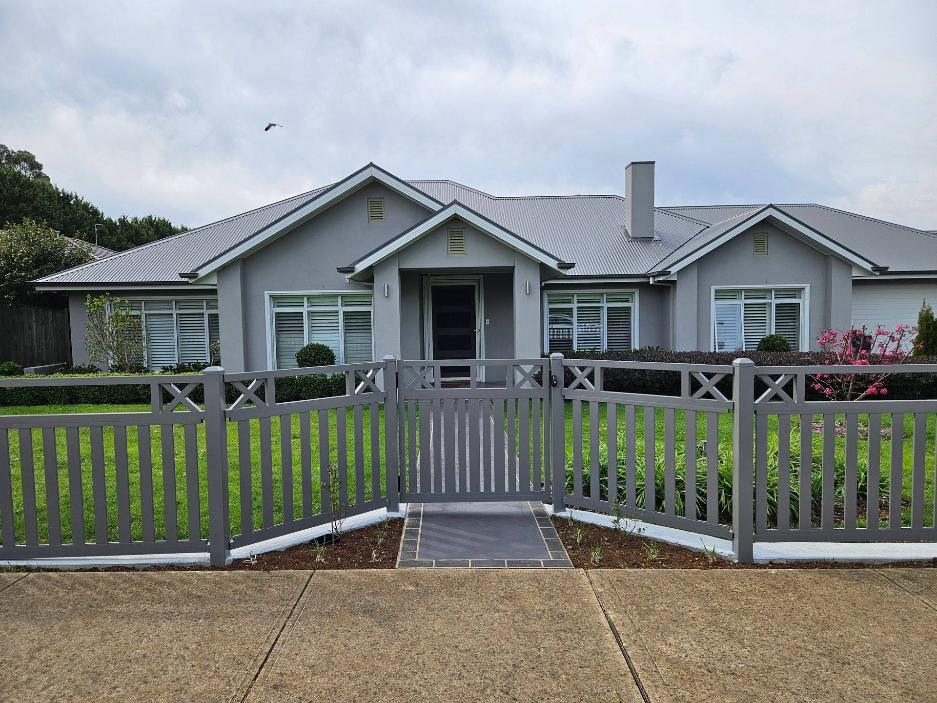 A large house with a fence in front of it