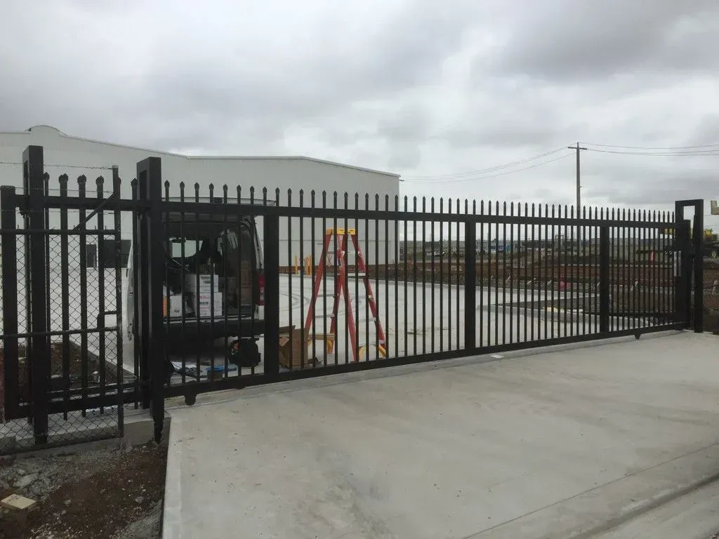 A black fence with a ladder in front of it