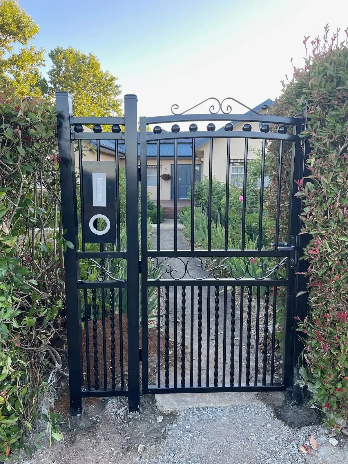 A black gate with the letter o on it