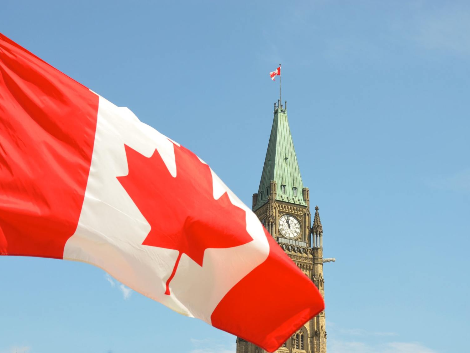 Canadian flag hoisted in front of Parliament Hill in Ottawa