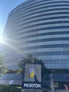 Morton Salt corporate building with a large Morton Salt girl logo. Sunny day, exterior view.