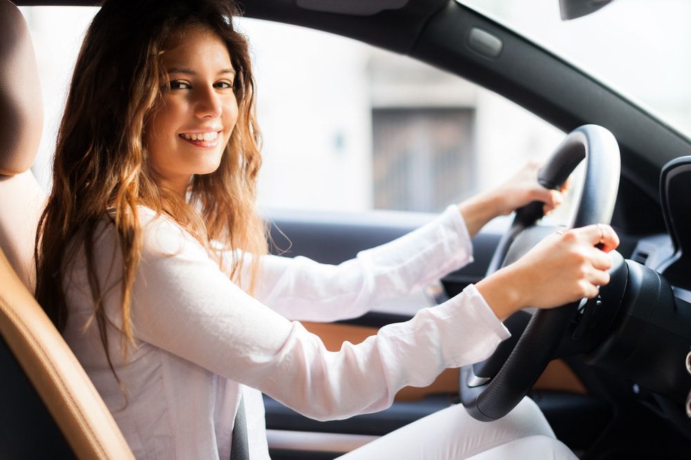 A Woman Is Sitting in The Driver 's Seat of A Car — ORH Mechanical in Doolbi, QLD
