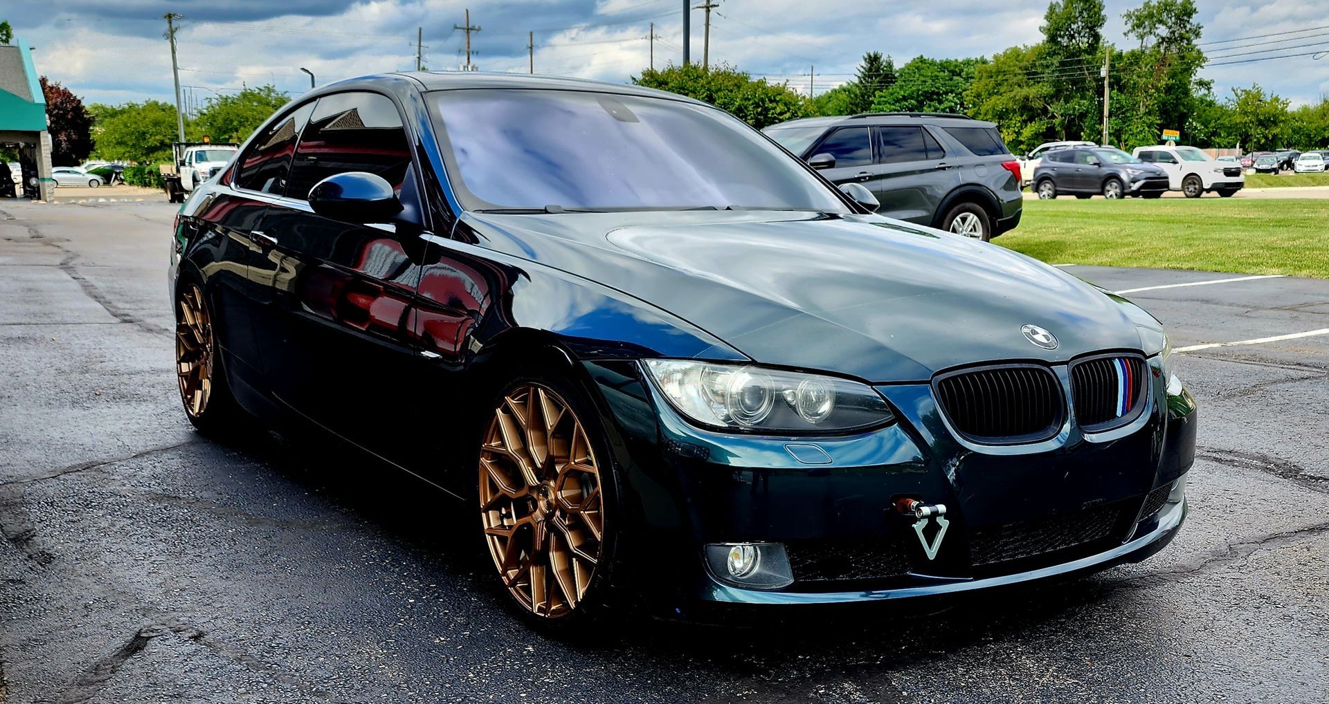 A man is polishing a car with a machine.