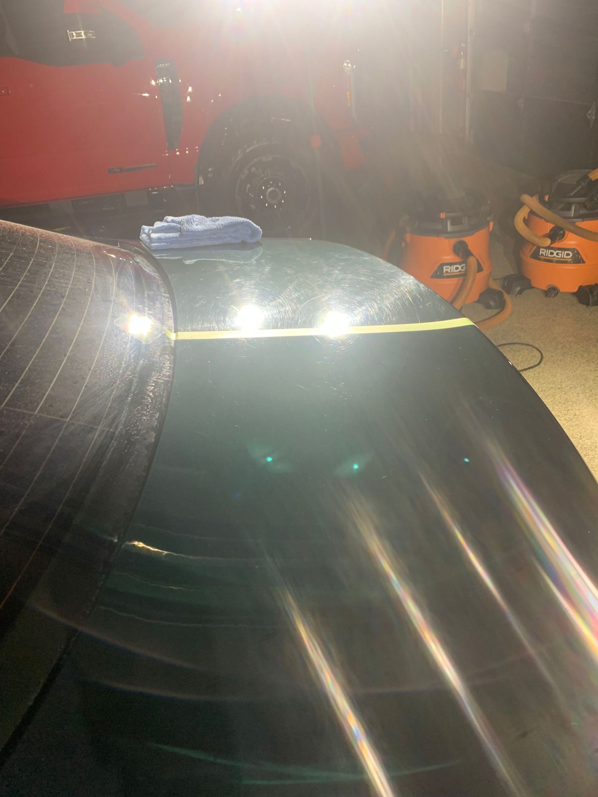 A close up of a car windshield in a garage.