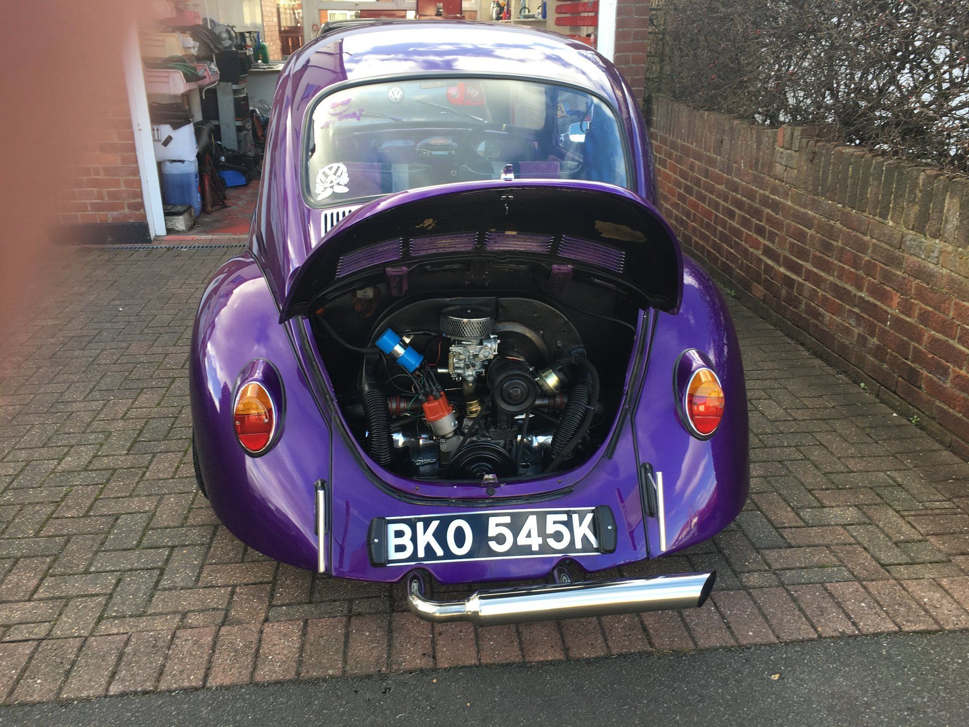 purple classic car with boot open