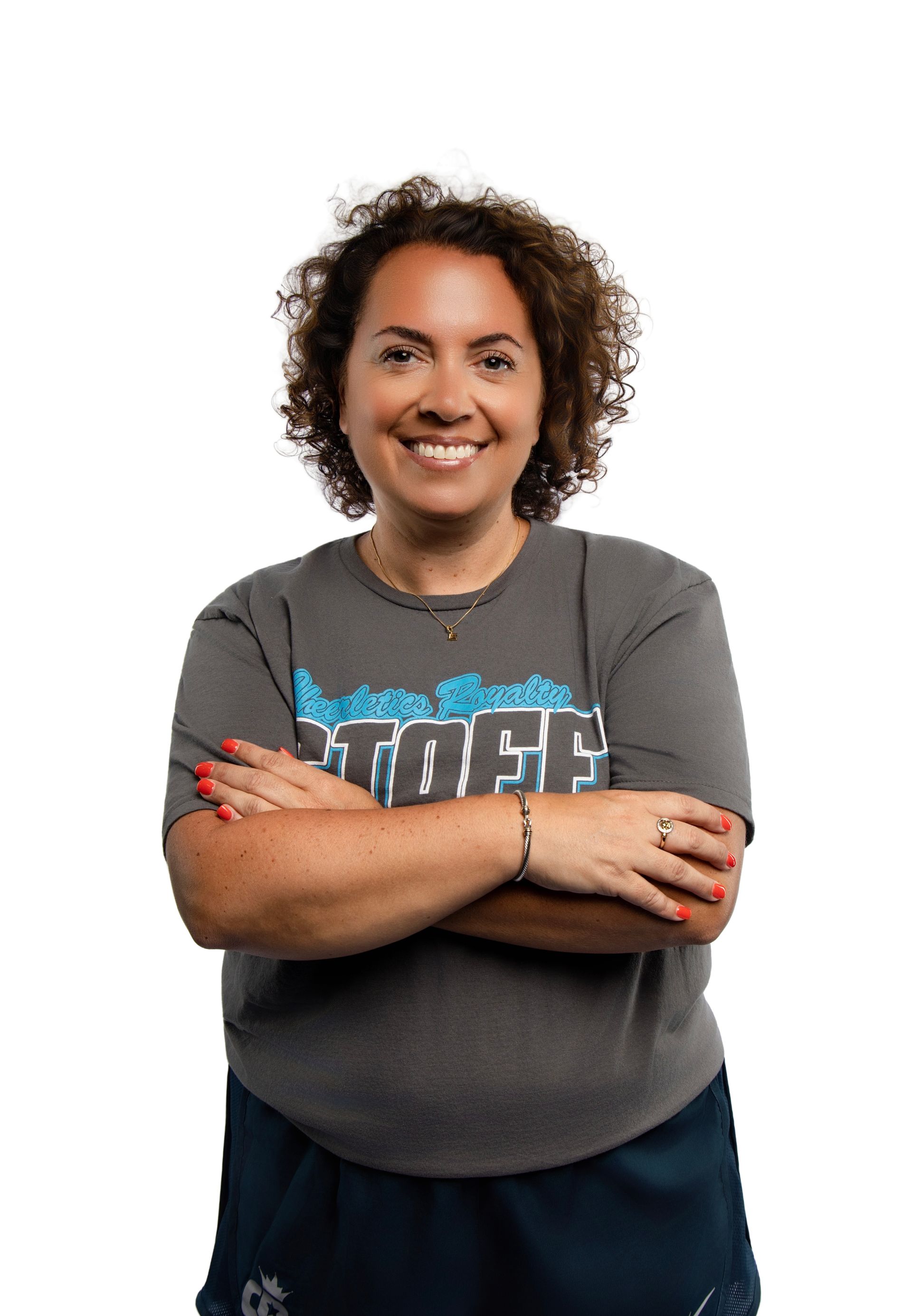 A young man with a beard is smiling for the camera while wearing a brown jacket.