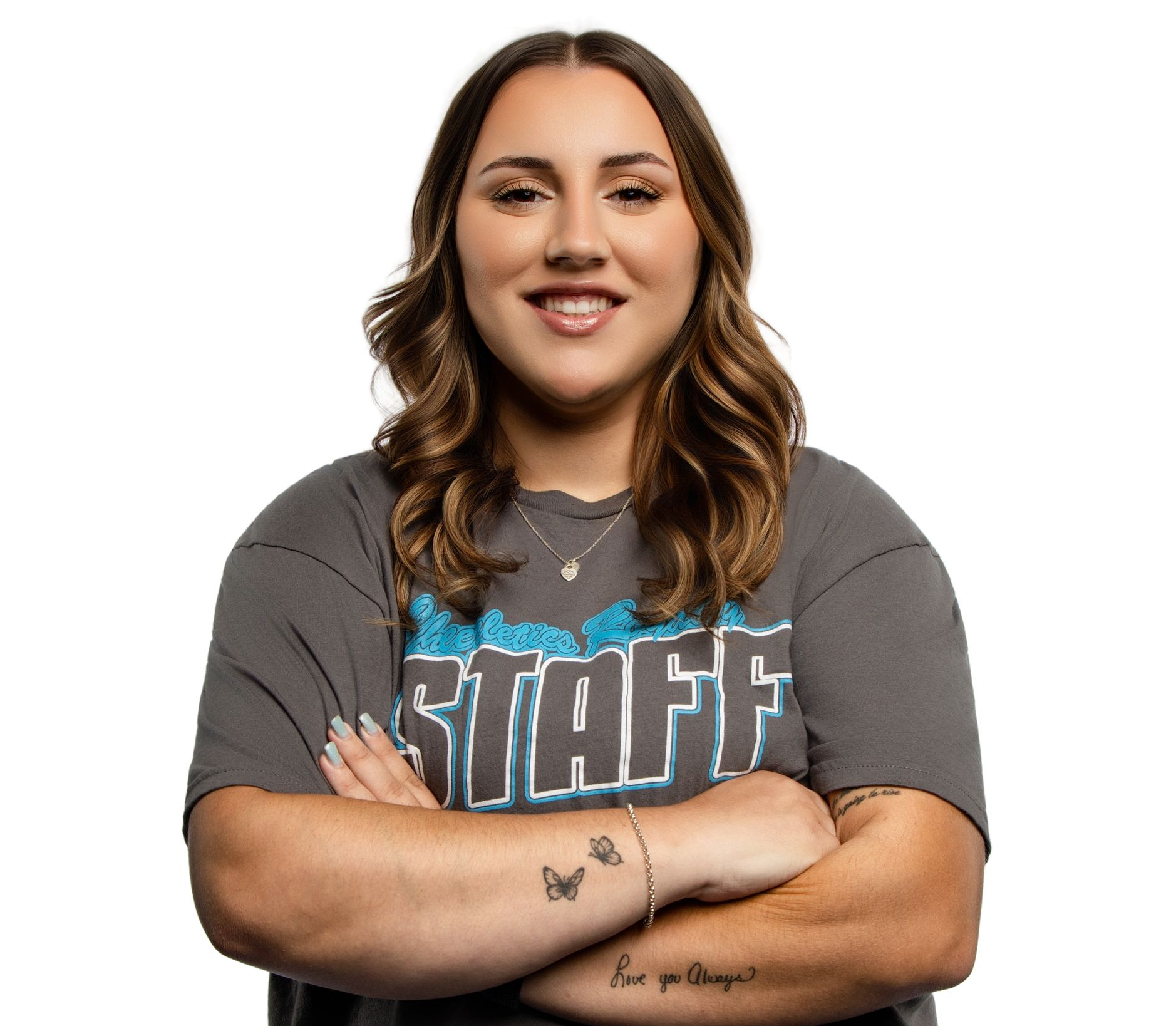 A woman wearing glasses and a turtleneck sweater is smiling.