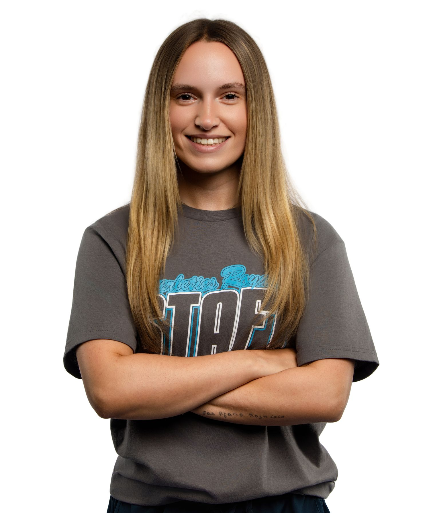 A woman wearing glasses and a turtleneck sweater is smiling.