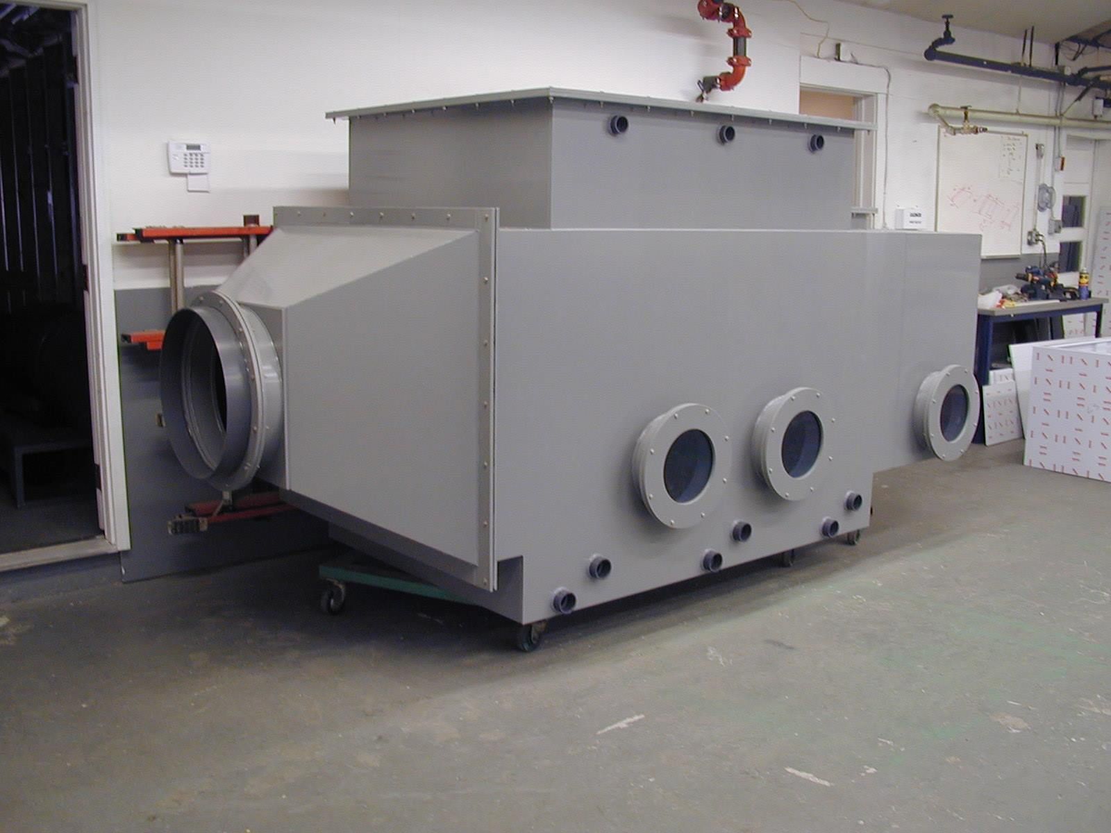 A large gray box with holes in it is sitting in a room.