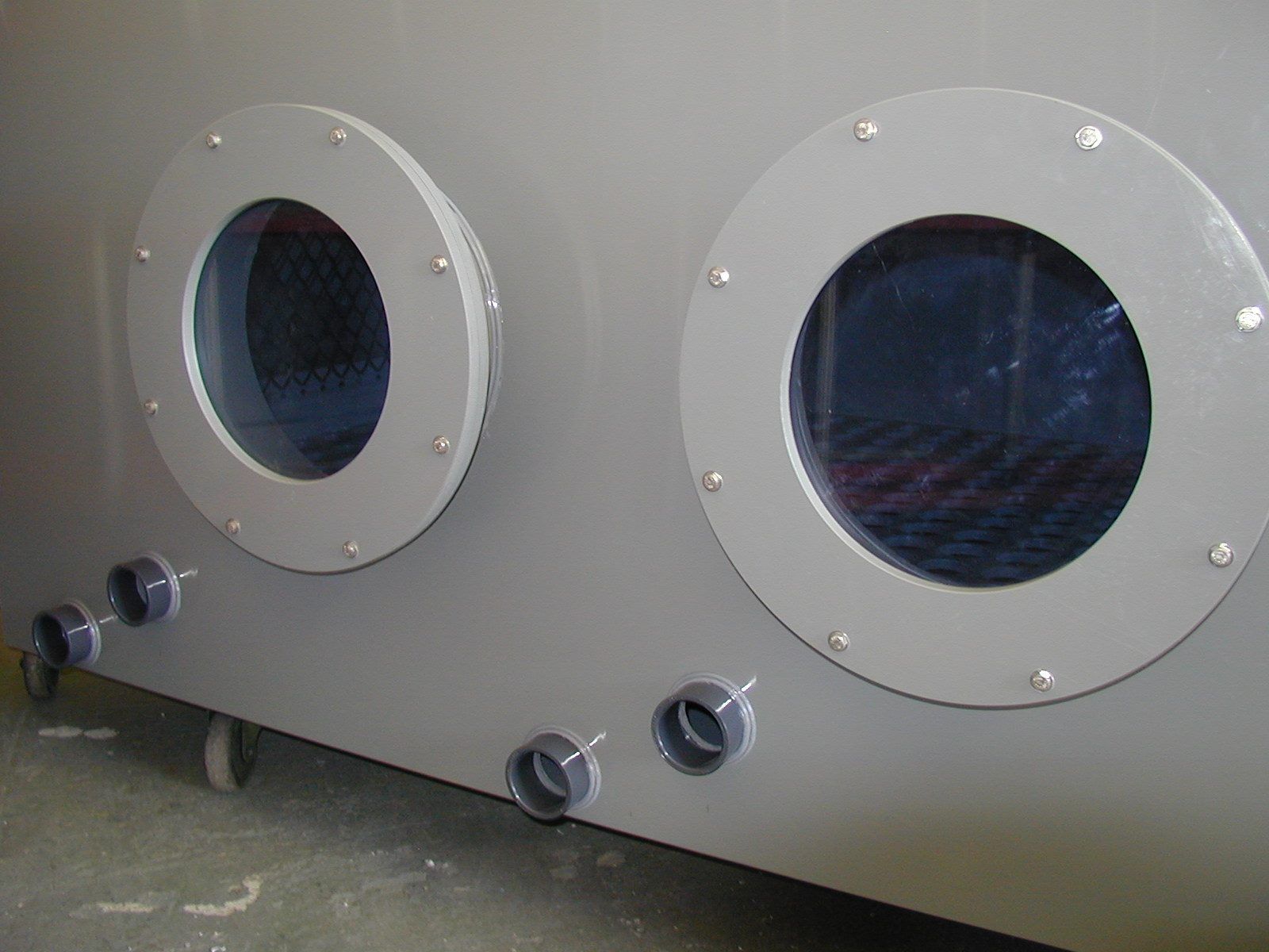 A gray container with two round windows on the side.