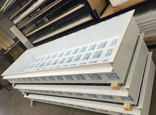 A stack of white acrylic sheets sitting on top of each other.