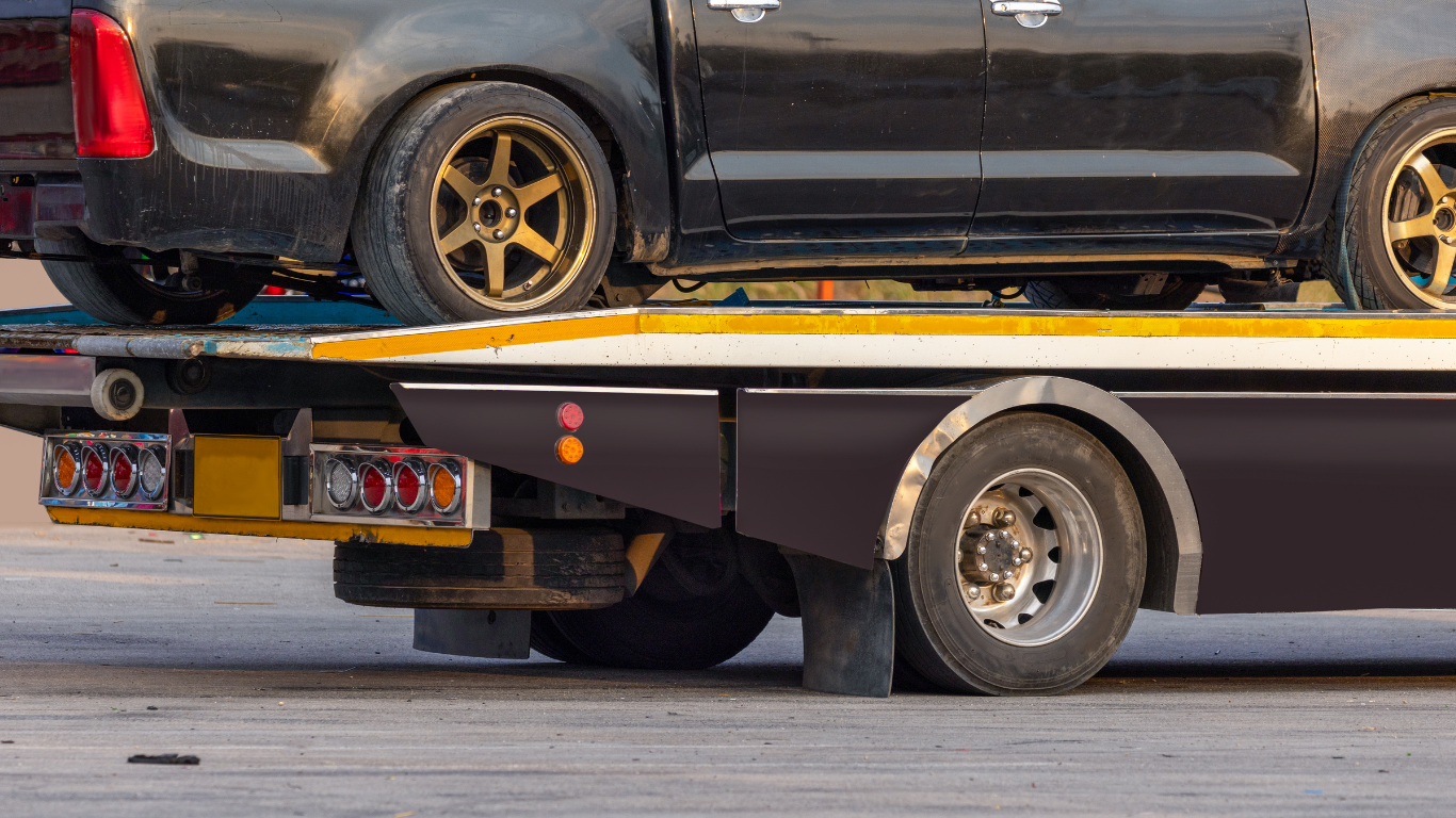 A white trailer is parked on the side of the road.