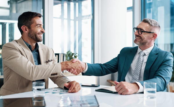 A group of people are sitting in a room clapping their hands.