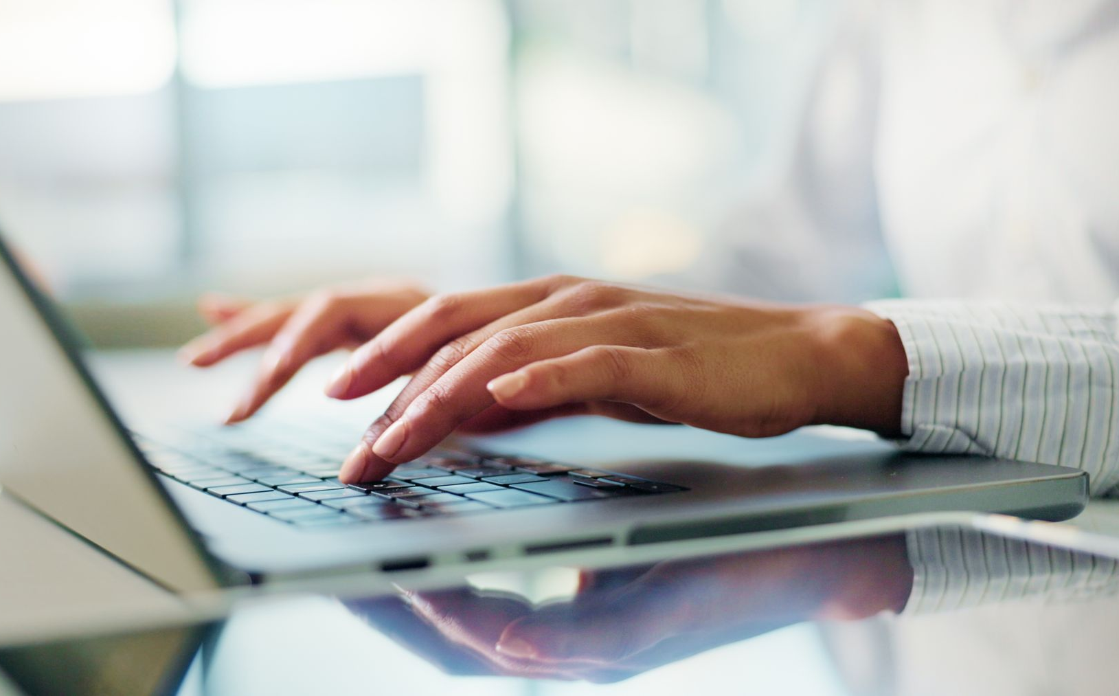 A group of people are sitting in a room clapping their hands.