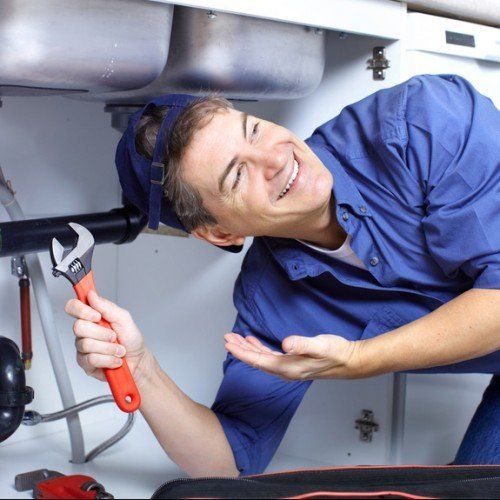 Professional plumbing man holding wrench
