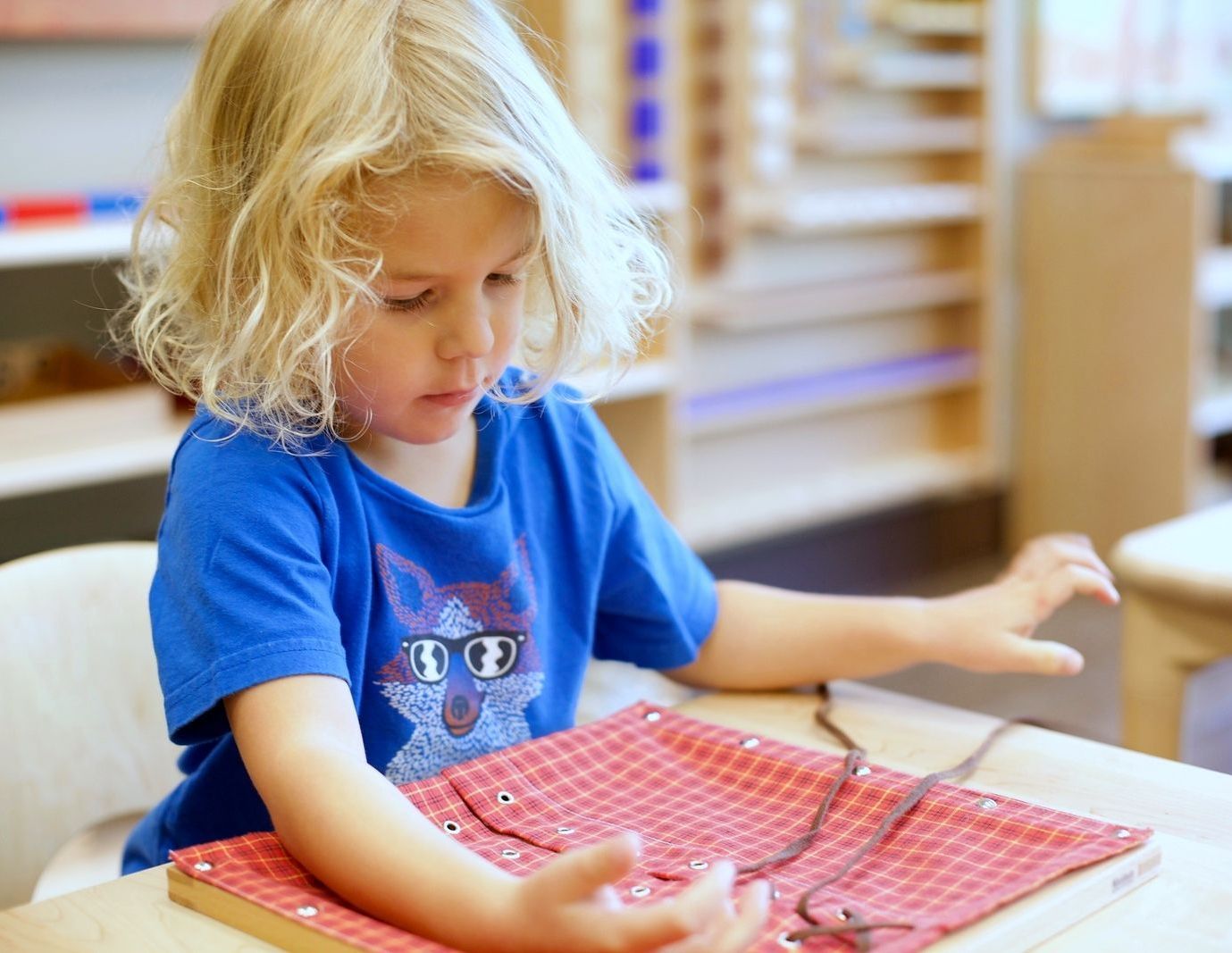 Montessori child  working on practical life skills