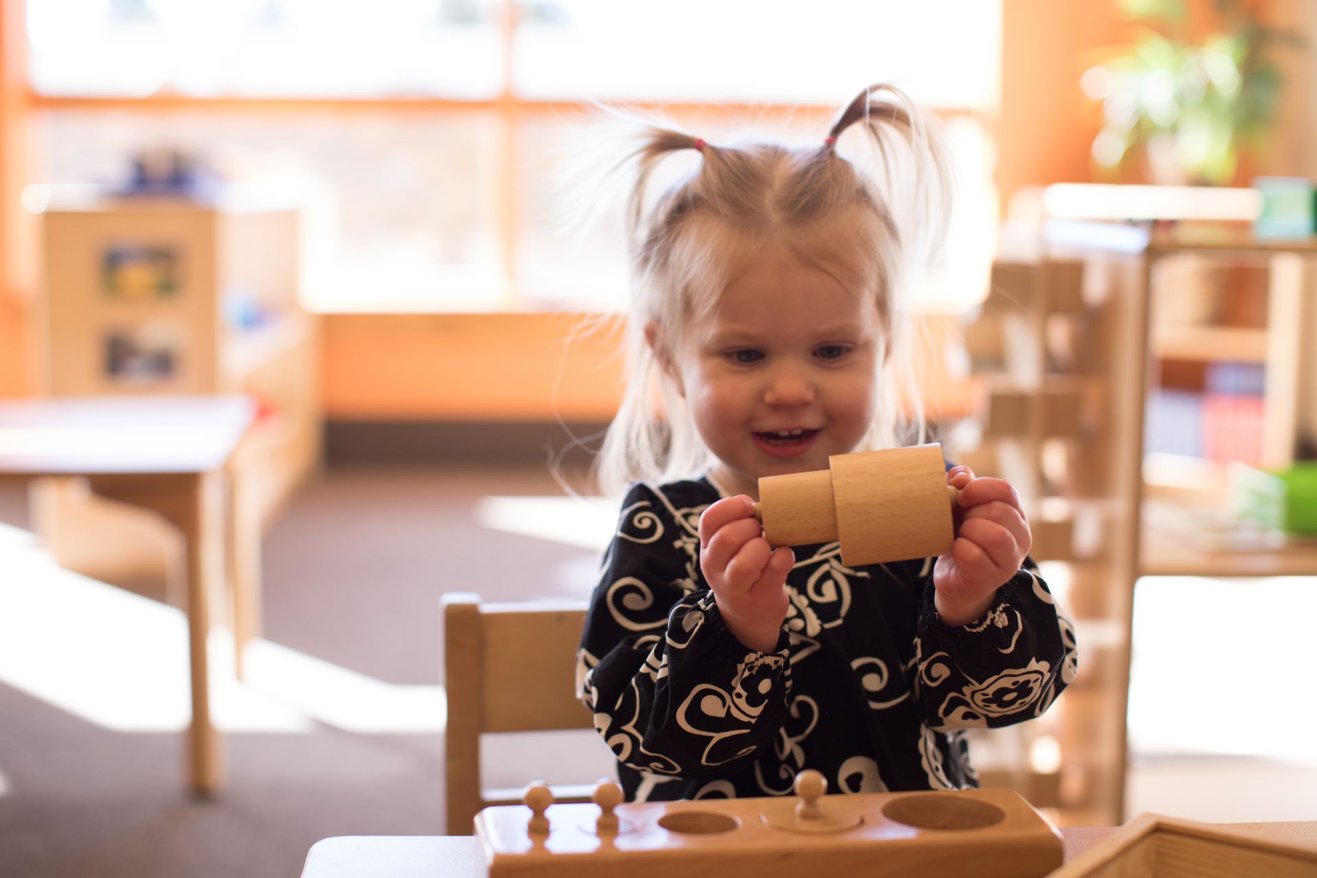 Child working with the Montessori knobbed cylinders