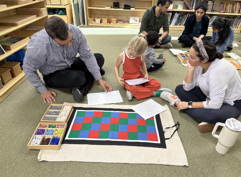 Montessori child and adults working in the classroom