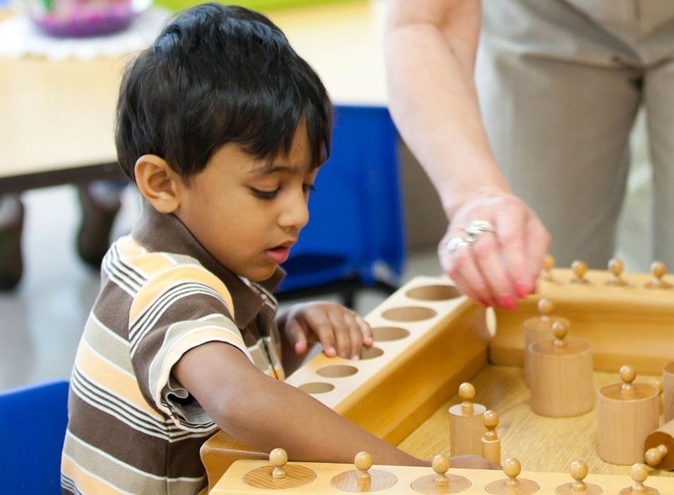 Child working with Montessori Knobbed Cylinders