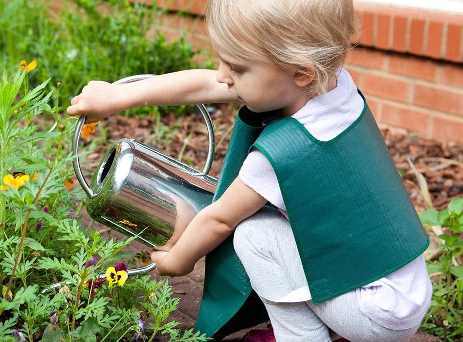 Montessori child watering plants