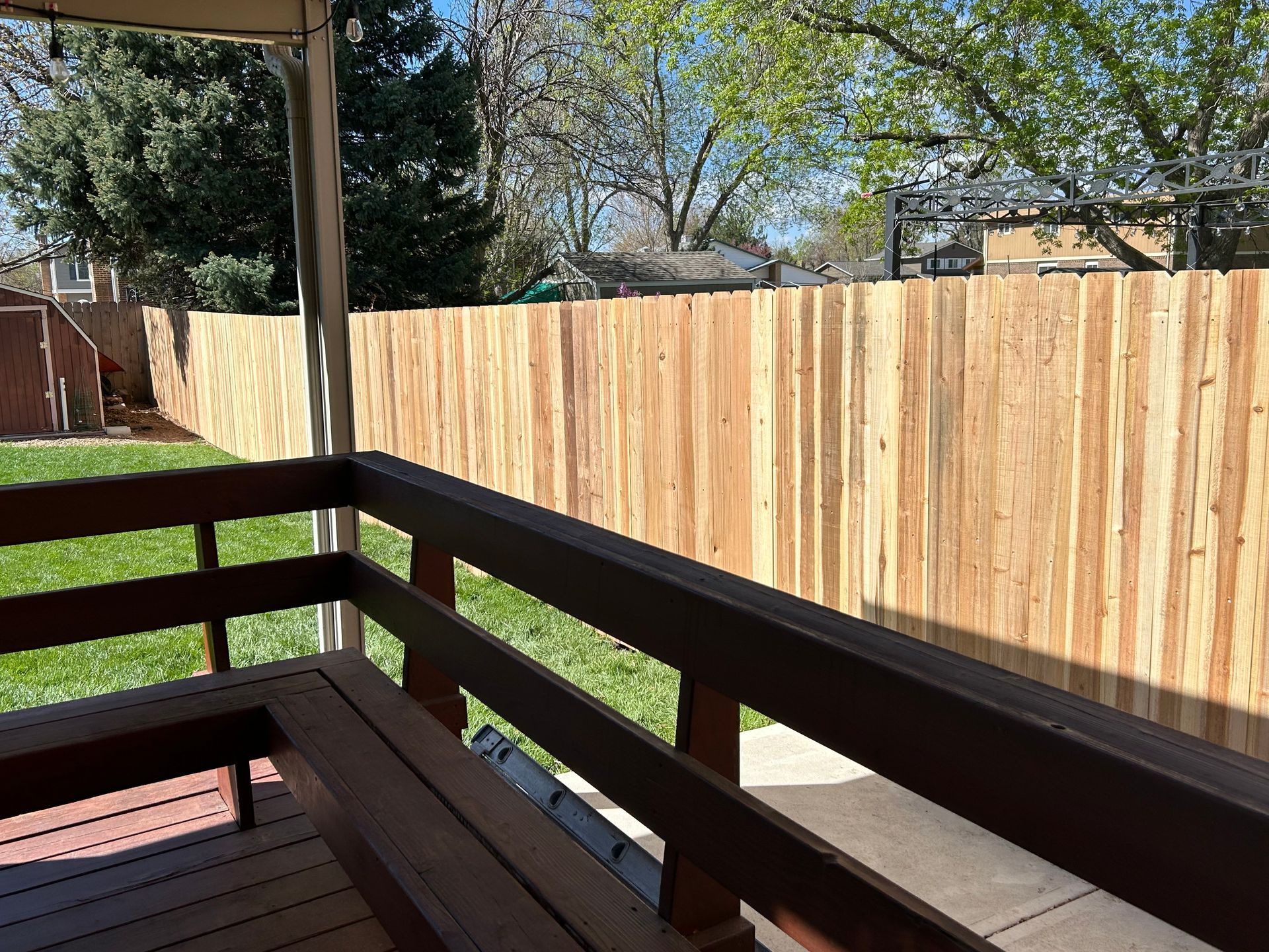 A wooden deck with a wooden fence in the background.