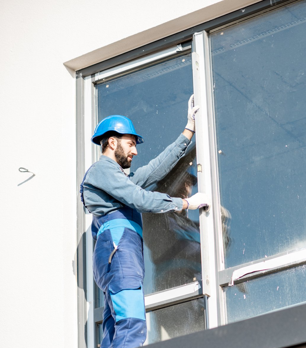 A man in a blue shirt is holding a wrench