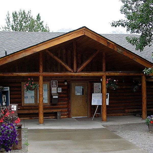A log cabin with a porch and a sign that says 4