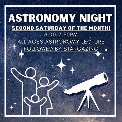 There is a bridge over a river with mountains in the background.