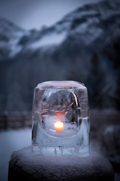 A man is standing on top of a mountain next to a boat.