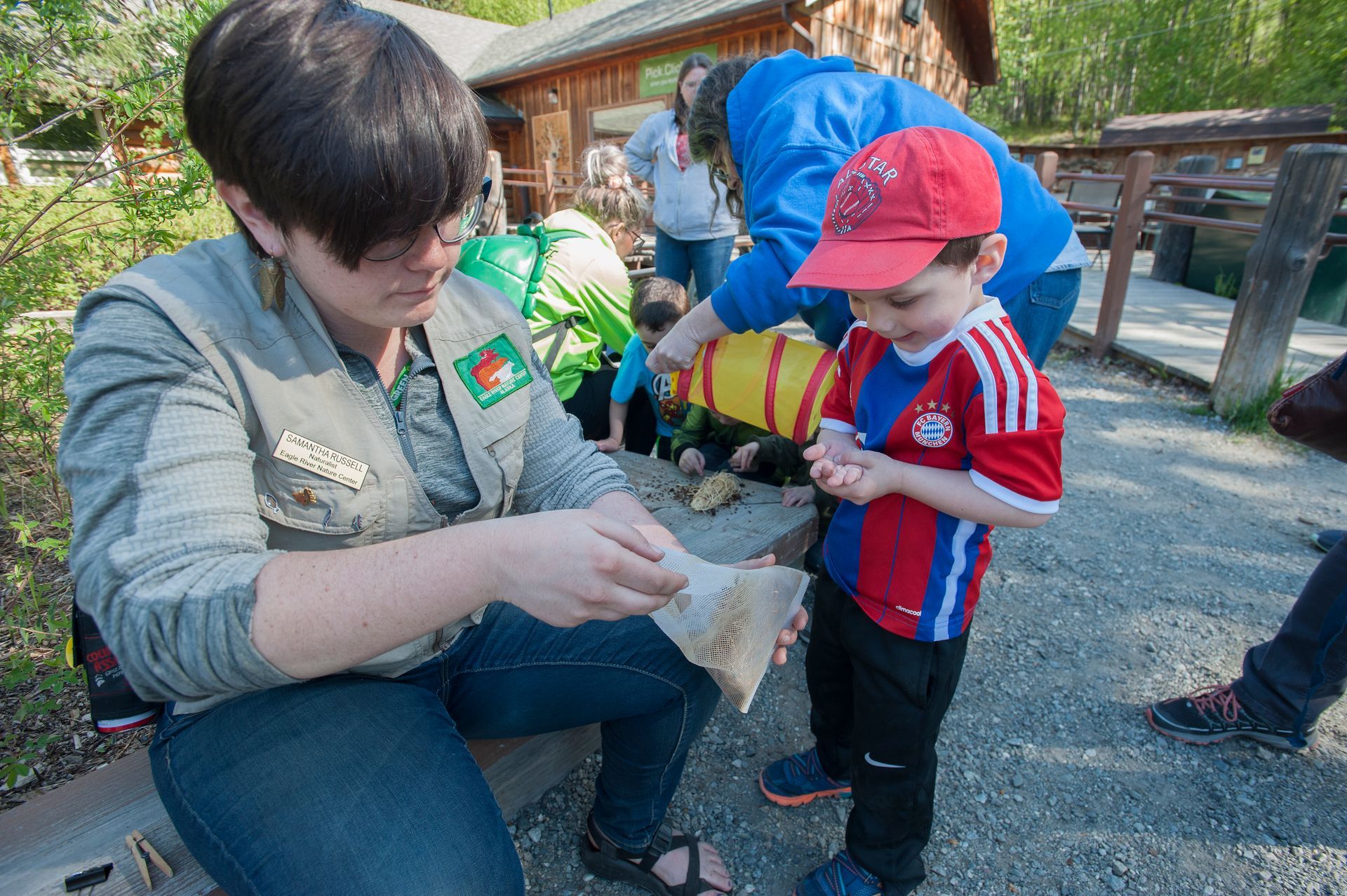 There is a bridge over a river with mountains in the background.
