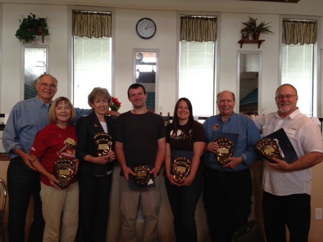 A group of people posing for a picture holding plaques
