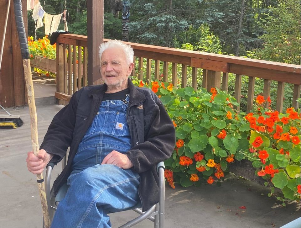 A button for the eagle river nature center with a moose and a bear on it.