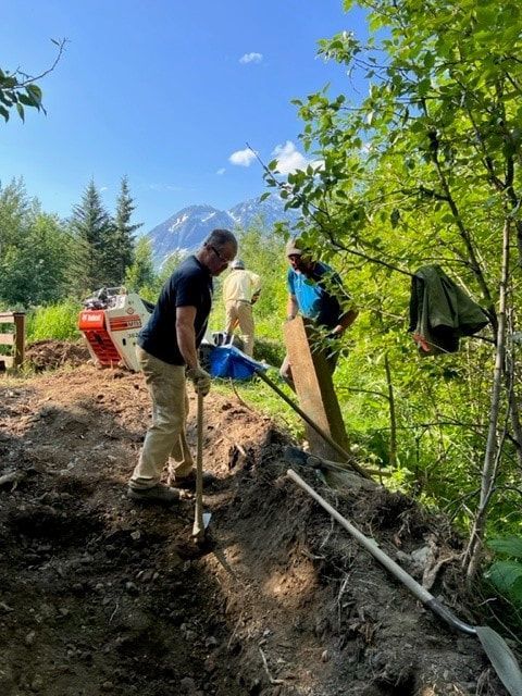 A group of people are digging in the dirt.