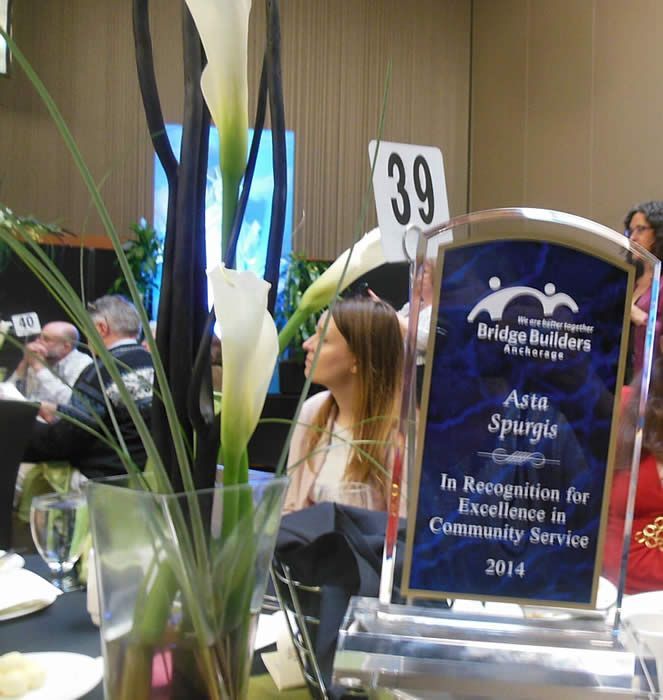 A plaque that says asia spurgis in recognition for excellence in community service