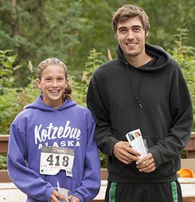 A man and a girl are posing for a picture together.