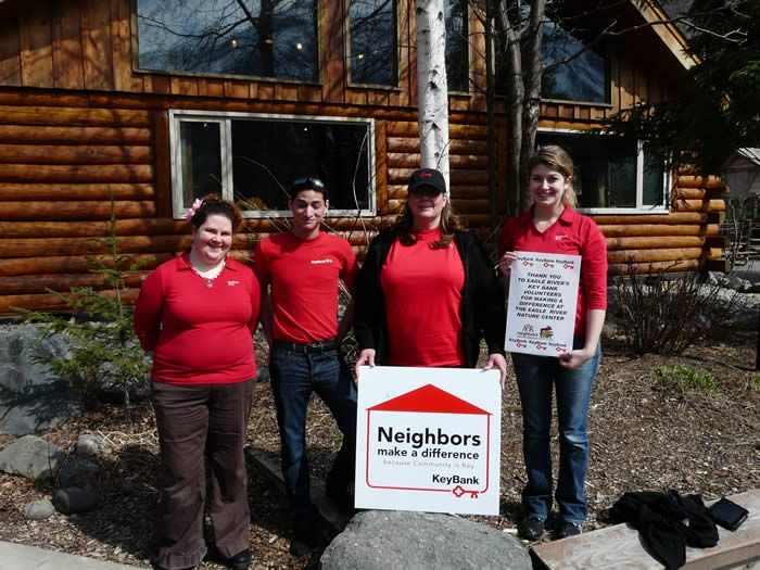 A group of people holding a sign that says neighbors