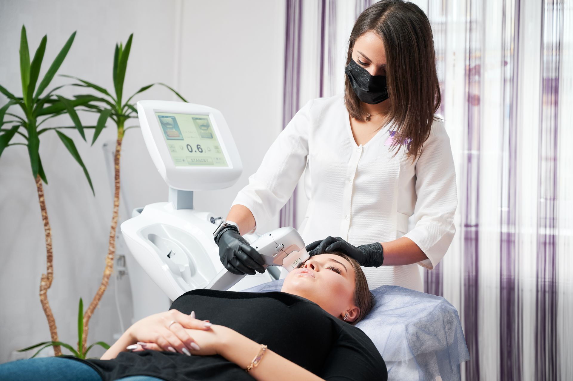 A woman is getting a facial treatment at a beauty salon.