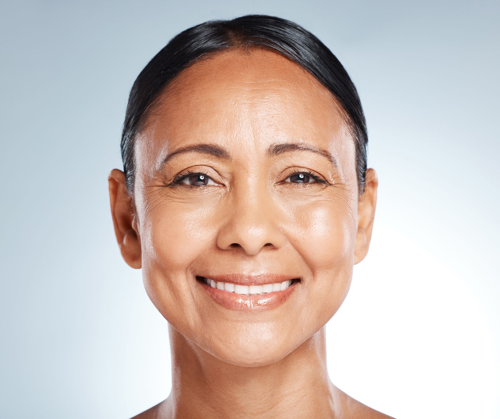 A close up of a woman 's face with a smile on her face.
