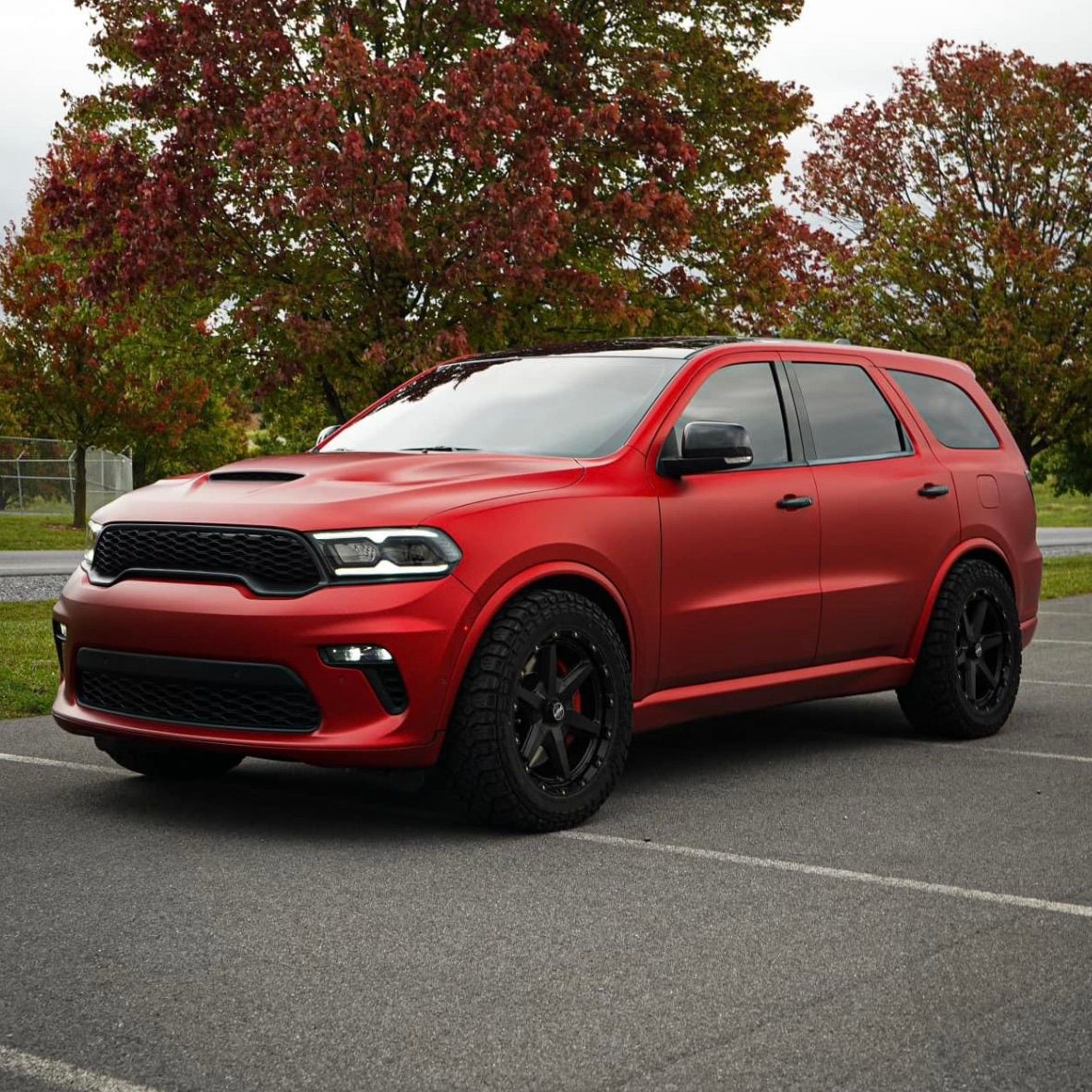 Green Subaru WRX with black accents parked on asphalt. Black-tinted windows.