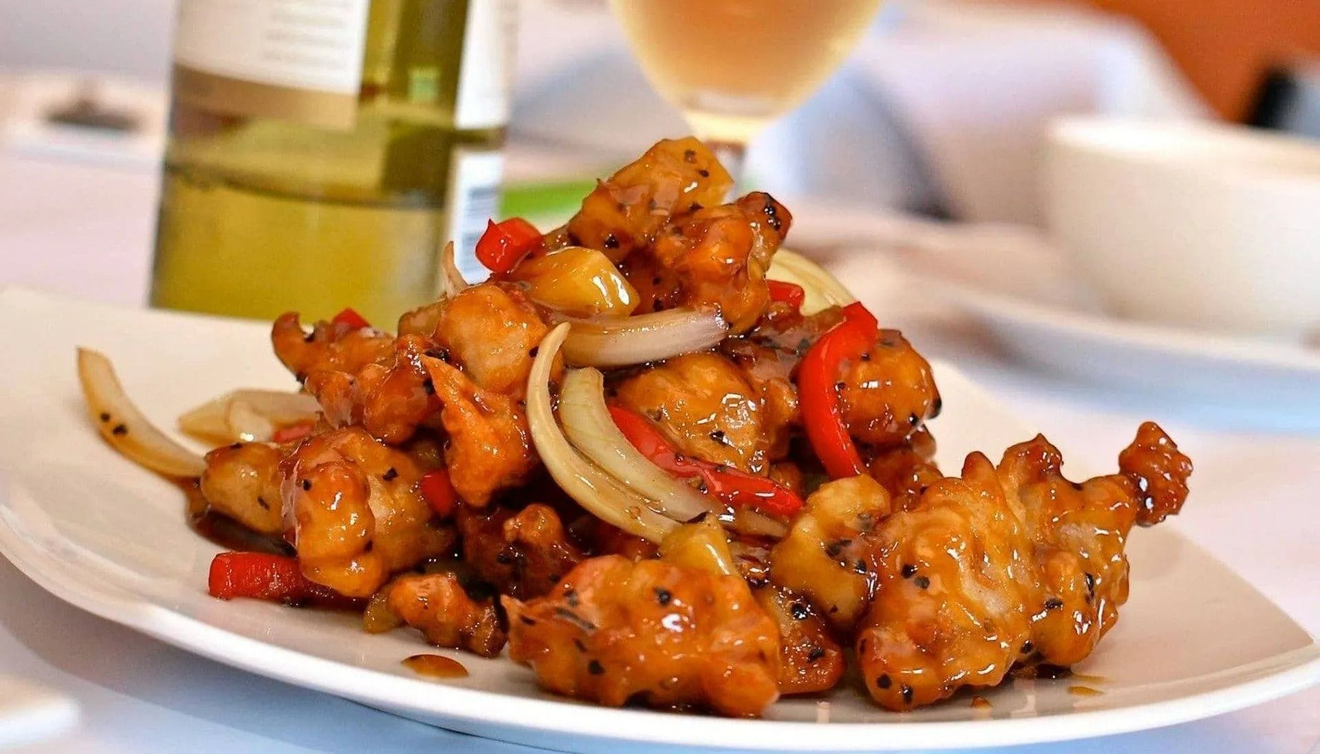 Plate of Sweet and Sour Chicken With Onions and Peppers — L'il Buddha Asian Cuisine in Salamander Bay, NSW