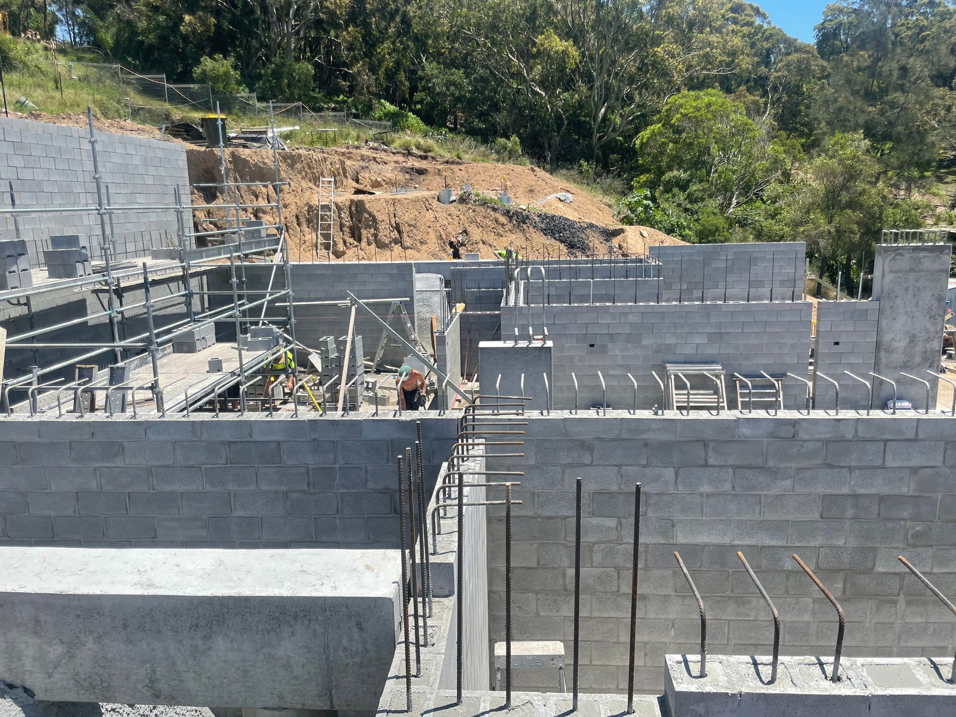 A construction site with a lot of bricks and scaffolding.