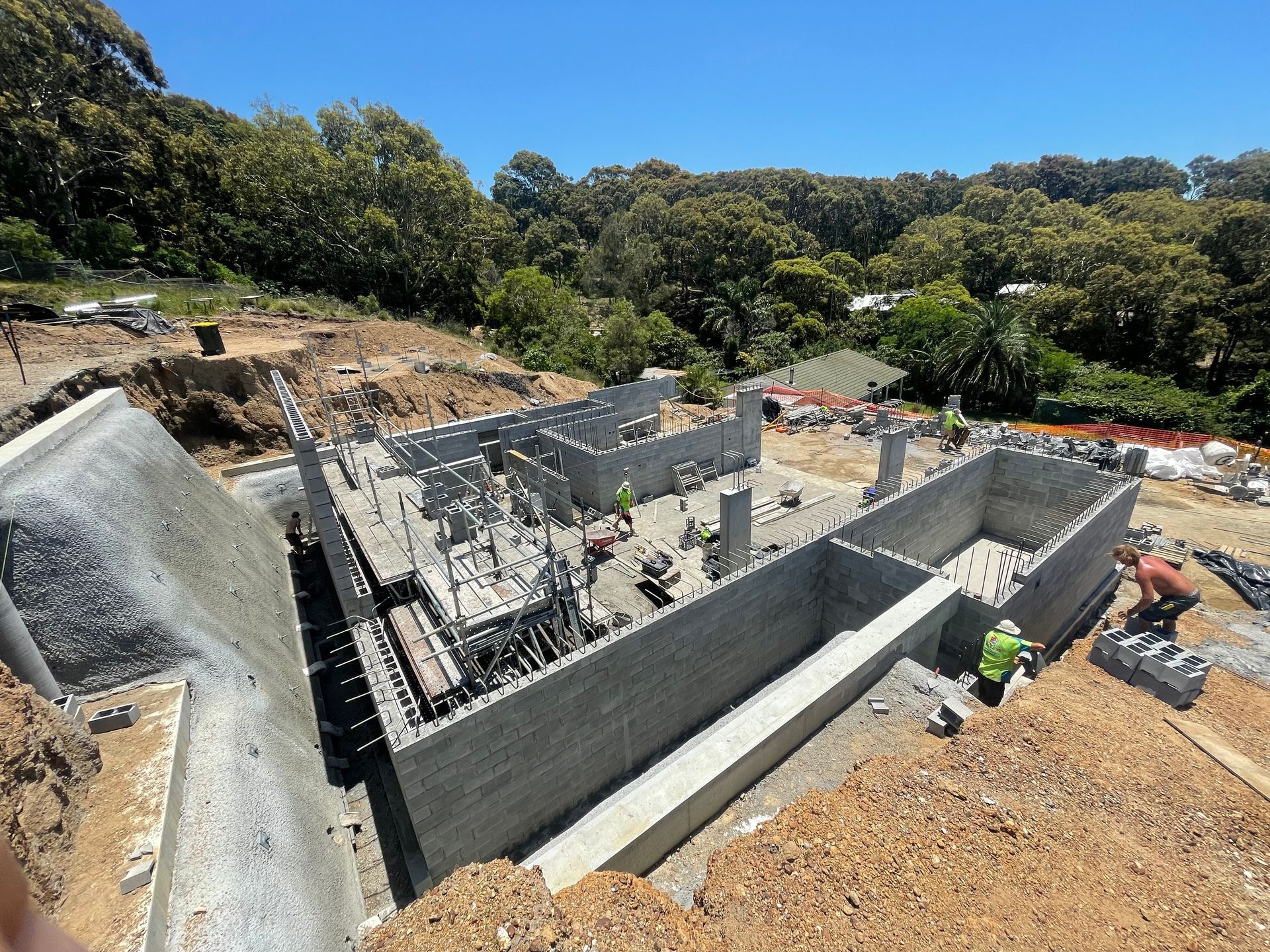 A house is being built with bricks and scaffolding.