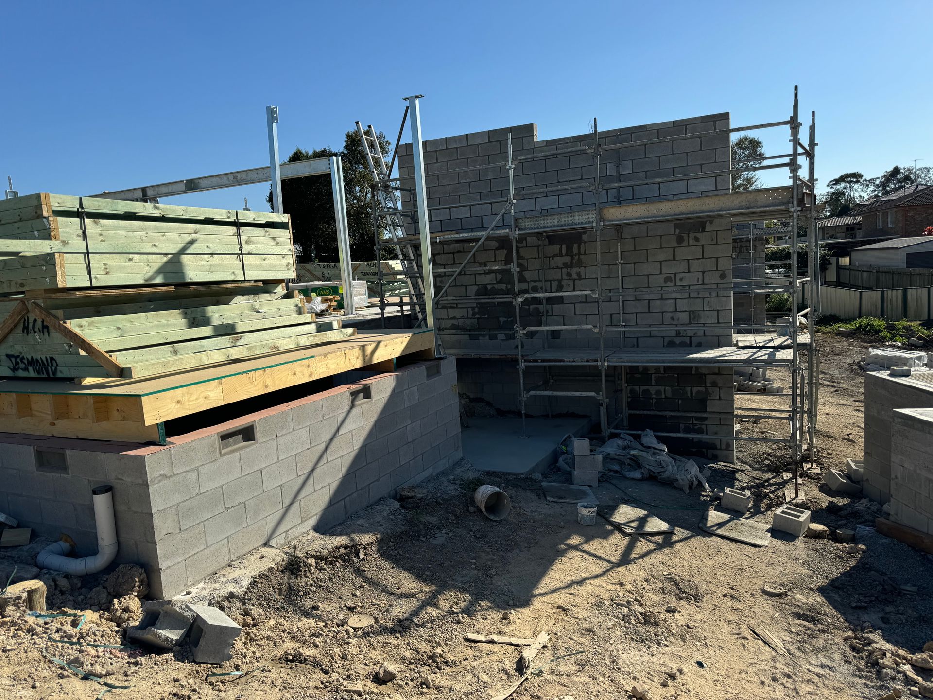 A group of construction workers are working on a brick wall.