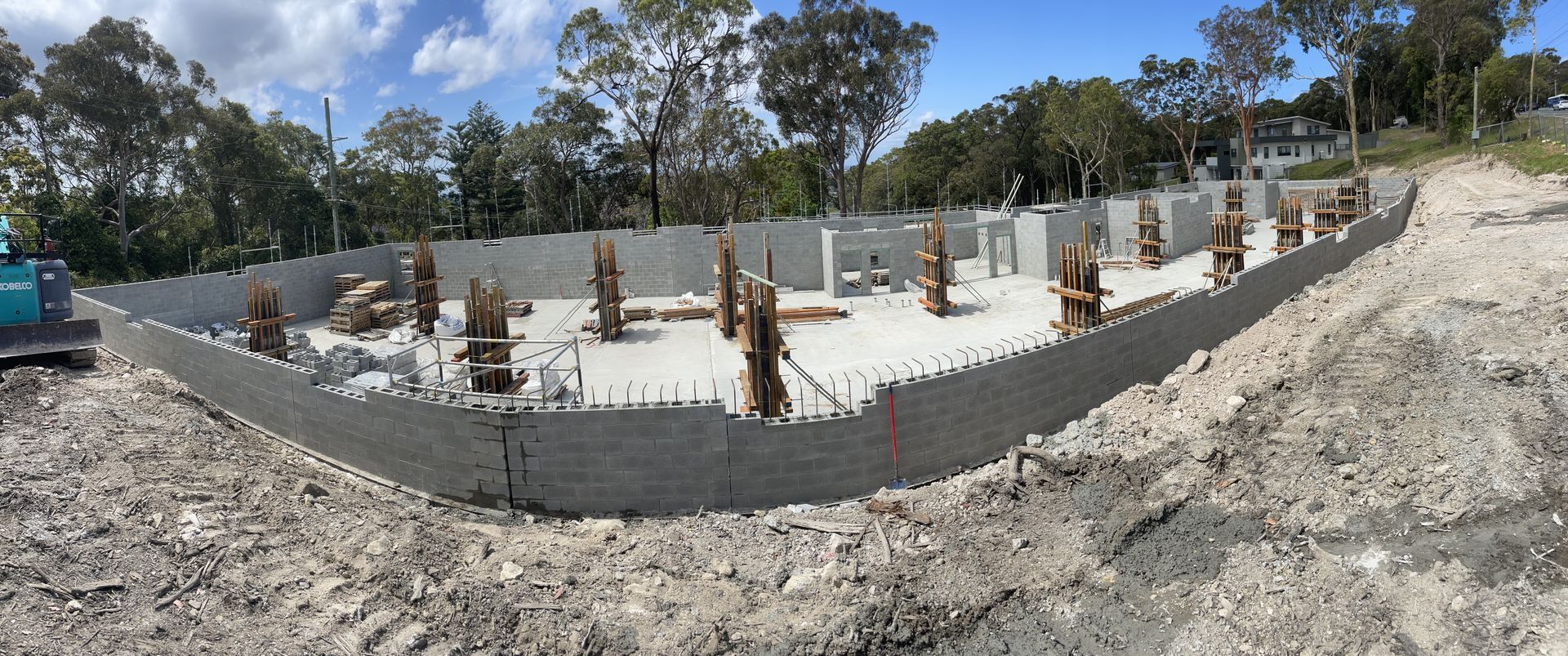 A house is being built with bricks in front of it.