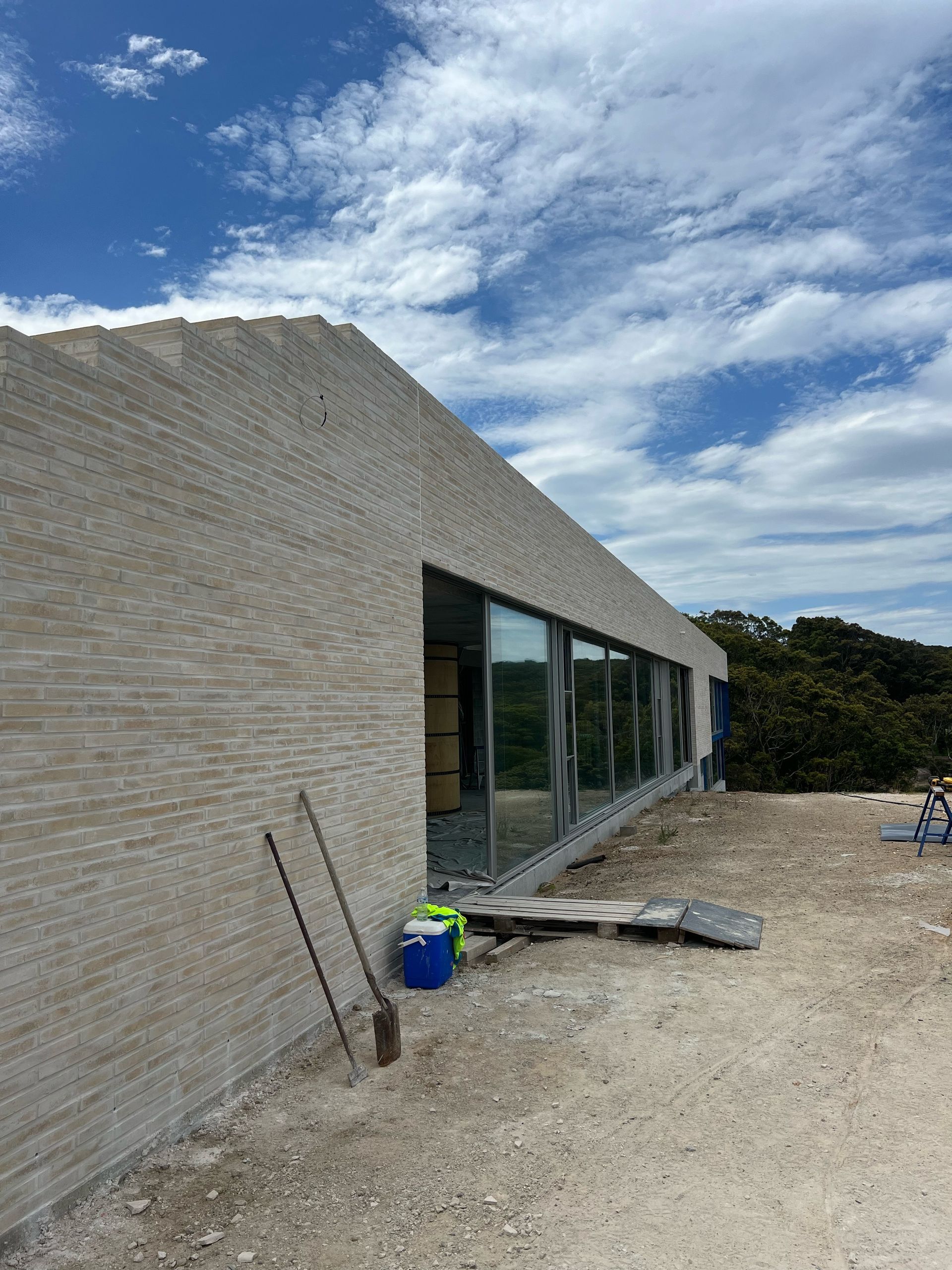 A man is standing on top of a building under construction.