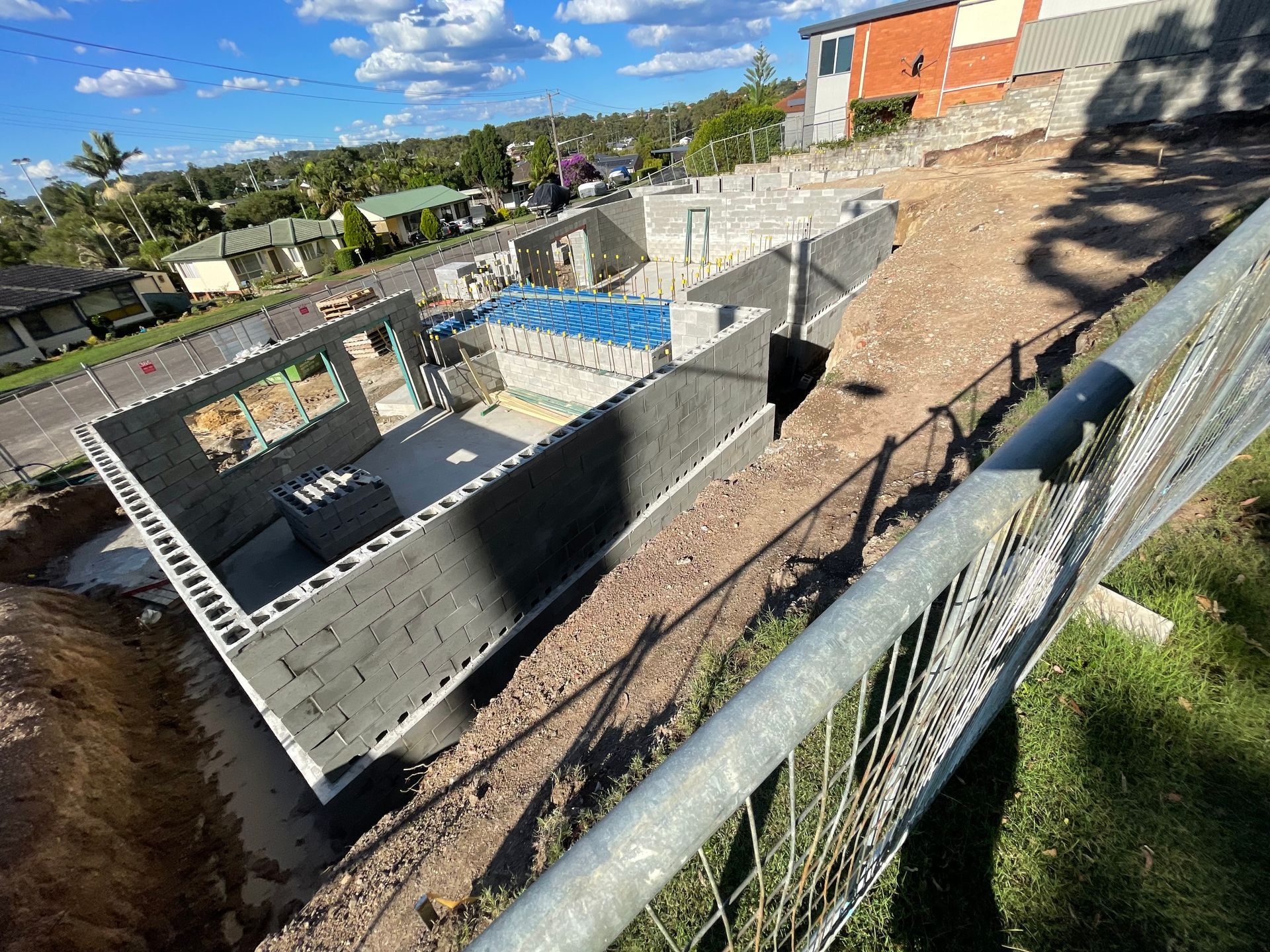 A yellow level is sitting on top of a brick wall