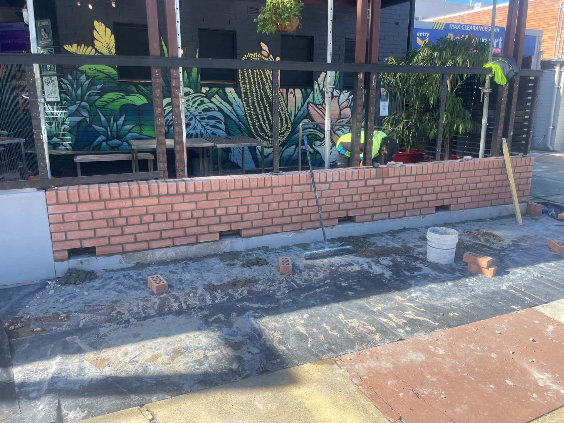 An aerial view of a building under construction in a city.